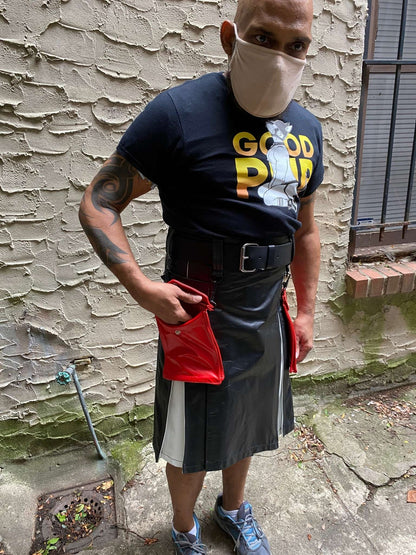 Model wearing leather boy pride flag heritage kilt, with right hand in detachable red leather kilt pocket.