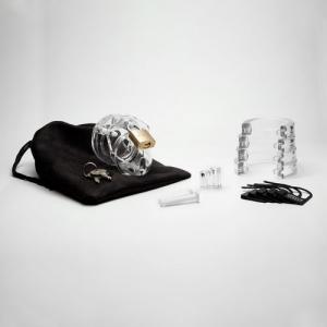 Image of all parts of the kit laid out. Chastity device that is locked together sits on top of a small black storage bag along with a set of two keys. Various sizes of ring that is placed behind testicles  are stocked on top of one another and spare plastic pins and plastic tag locks are nearby.