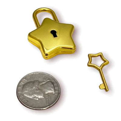 The gold Star Lock and key next to a quarter for size comparison.