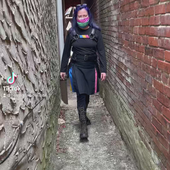 Model walks through alleyway, spins to show off the Pansexual Pride Flag Heritage Kilt.
