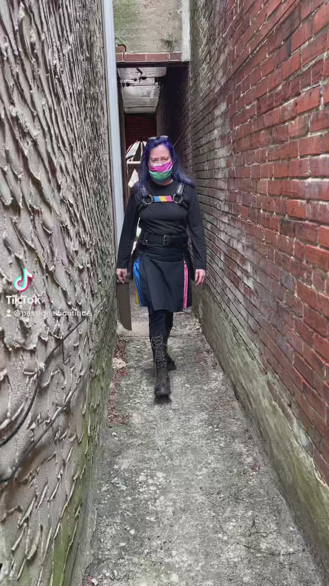 Model walks through alleyway, spins to show off the Pansexual Pride Flag Heritage Kilt.