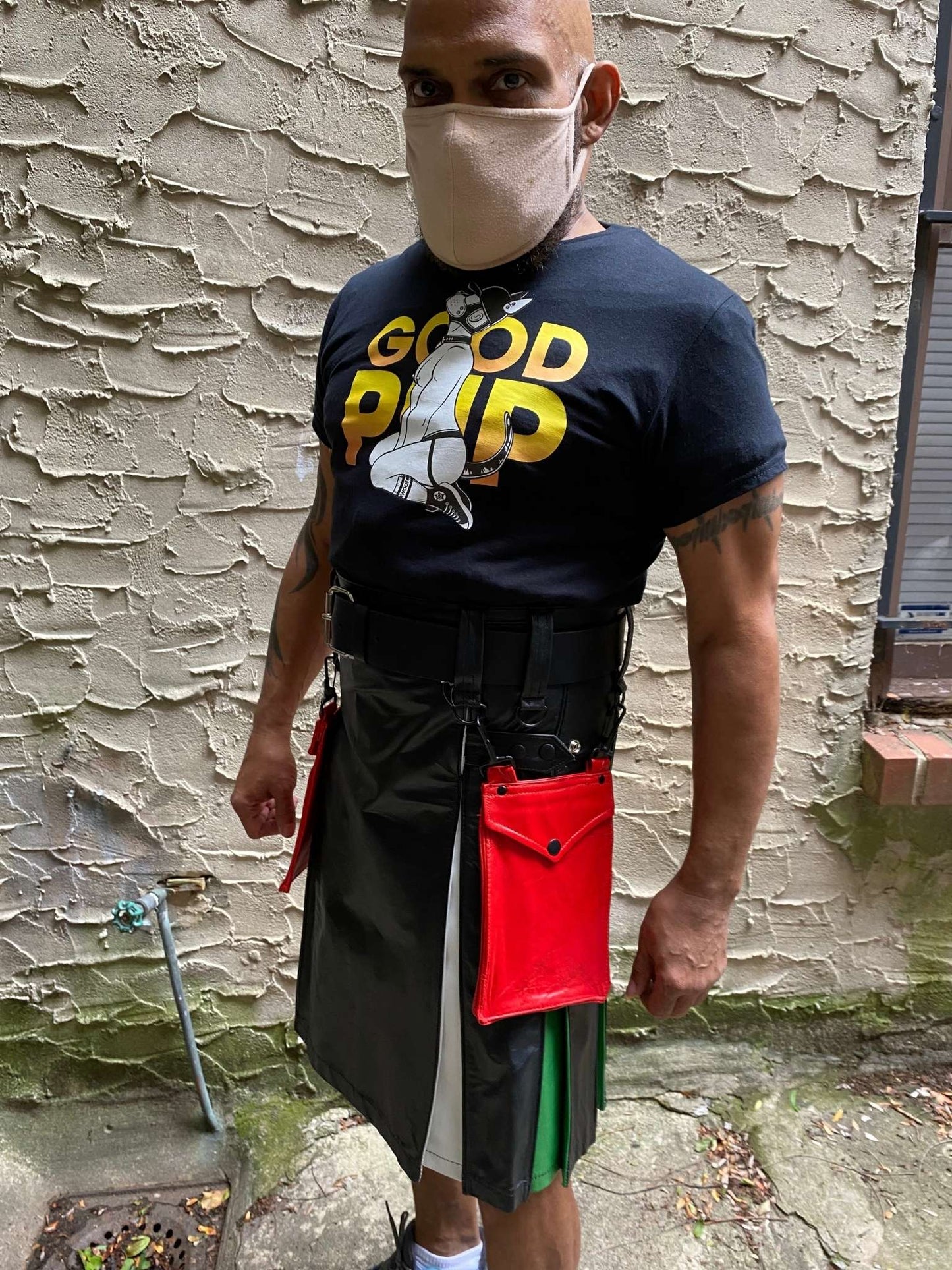 Model wearing the leather boy pride flag heritage kilt, with detachable red leather kilt pocket.