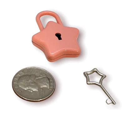 The pink Star Lock and key next to a quarter for size comparison.