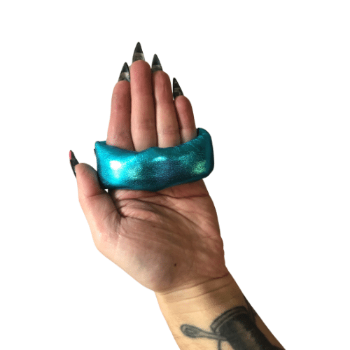 An open hand holding a metallic teal sap wrap. 