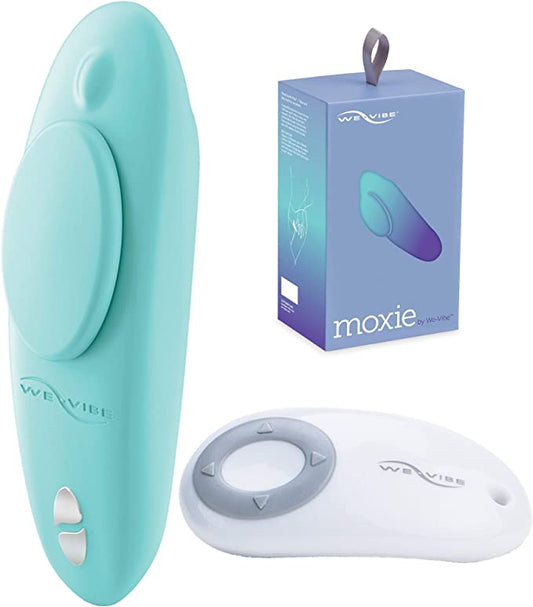 The Aqua We-Vibe Moxie+ Wearable Clitoral Vibrator next to its remote and packaging.