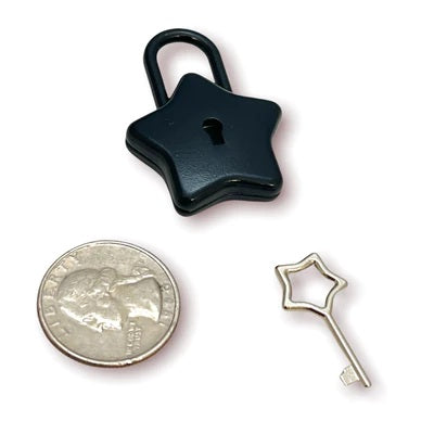 The black Star Lock and key next to a quarter for size comparison.
