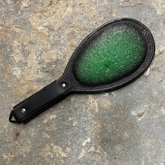 Green and black two toned Round Paddle with skeleton pattern.