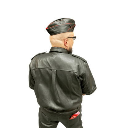 Model wearing leather garrison cap with red piping.