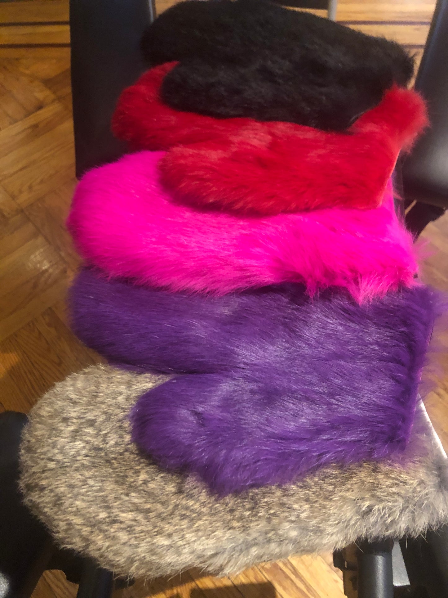 Full view of rabbit fur spanking mitts in color variants 