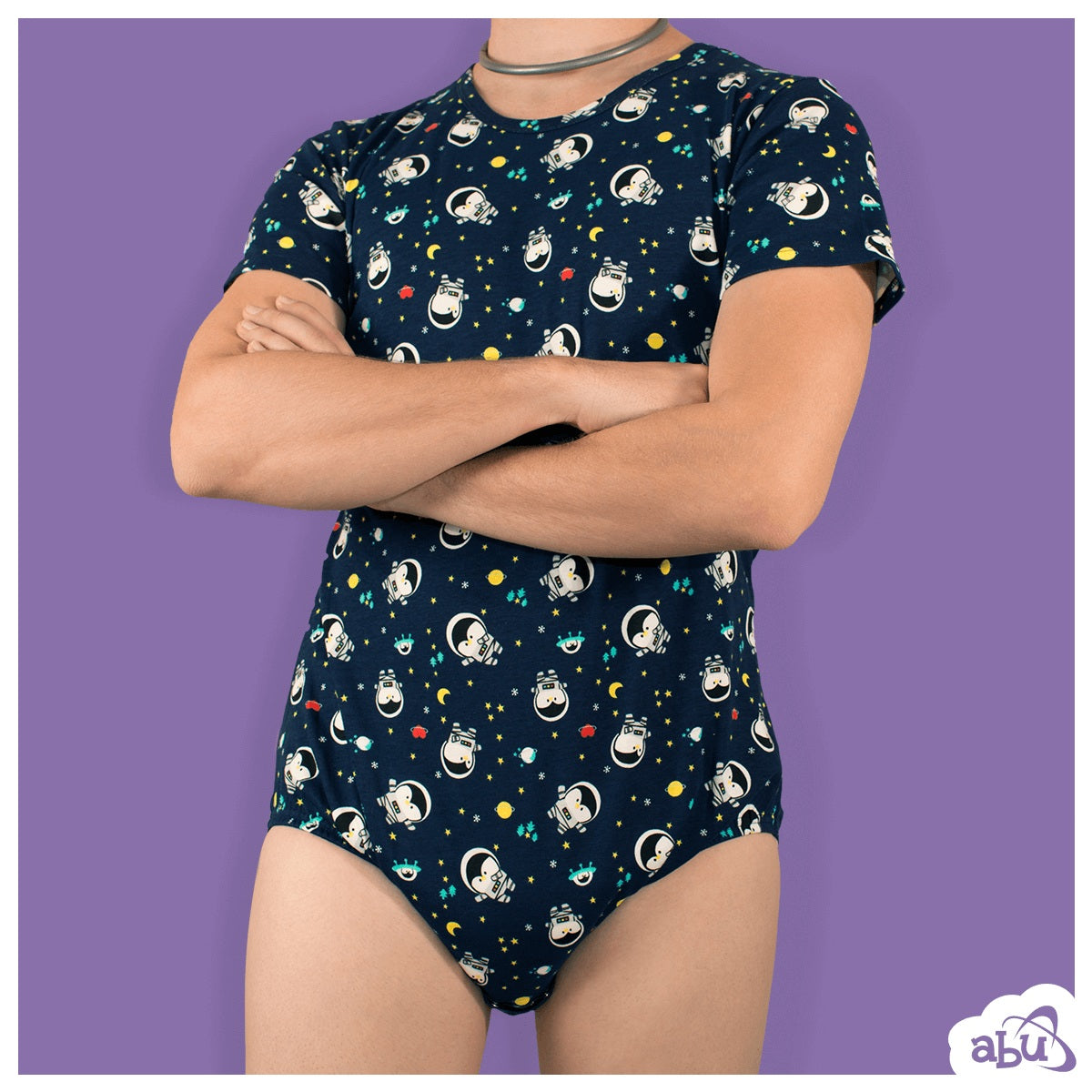 Front view of model wearing space penguins print diapersuit with disposable diaper worn underneath.
