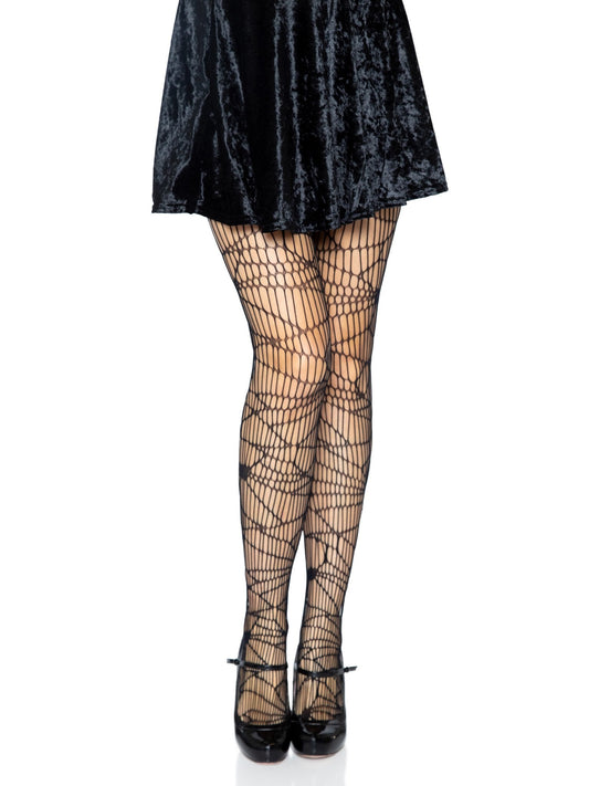 A model wearing the black Distressed Net Pantyhose with a black velvet mini skirt and black heels.