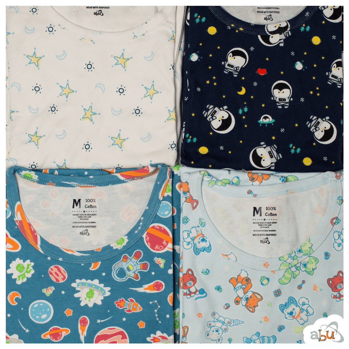 Diapersuits in all four patterns folded and laid out. Blue and yellow moons and stars on a white background. Penguins in space suits printed on a black background. Colorful planets, stars printed on blue background. Colorful animal characters printed on a light blue background.
