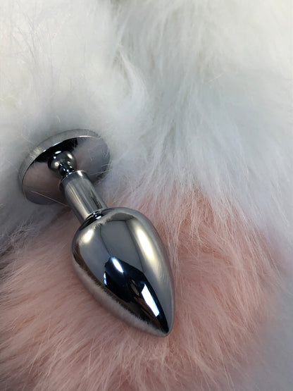 Faux white fur tail with pink tip. Close up of plug and tip.