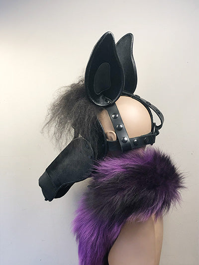 Black leather horse mask on a mannequin, left side view.