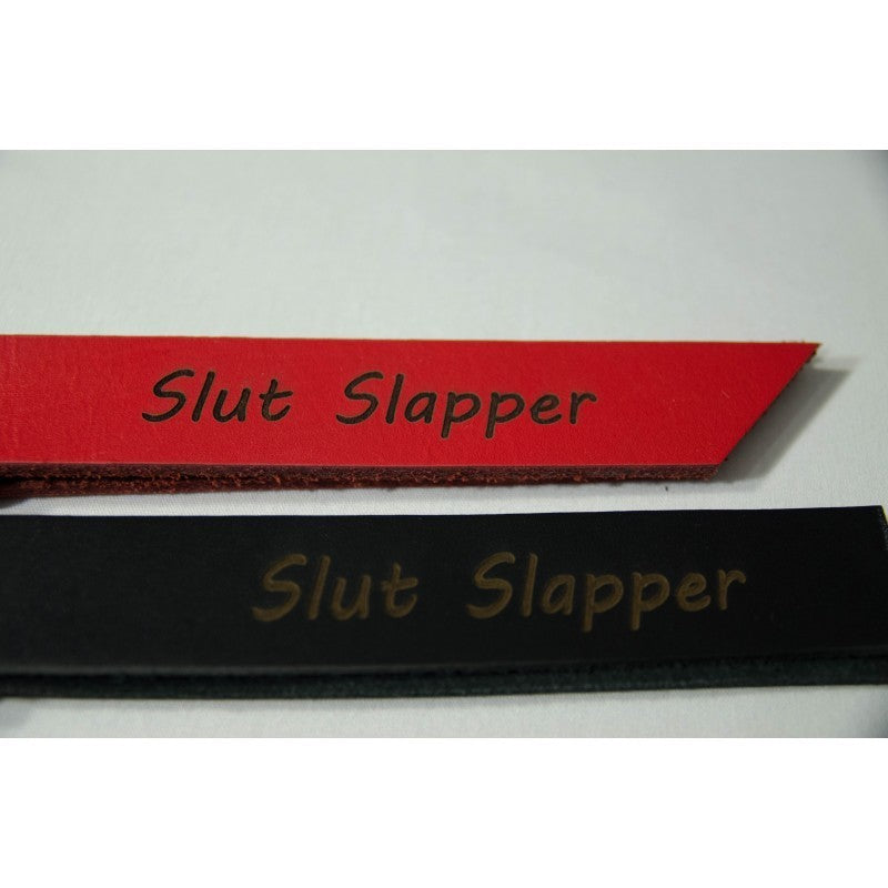1 inch red and 1 inch black leather slapper with the words slut slapper  