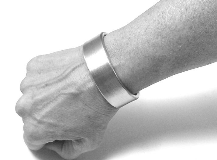 A model's wrist wearing the Titan Hephaistos Bracelet, front view.