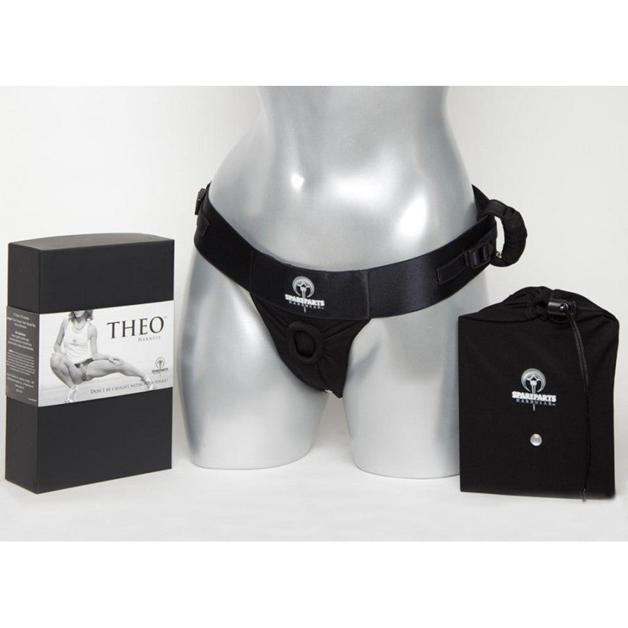The front of the pink Theo Thong Harness on a mannequin along with its packaging.