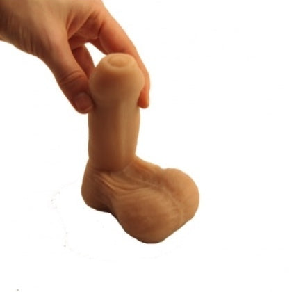 A hand holding the Pierre Packer Penis upright.