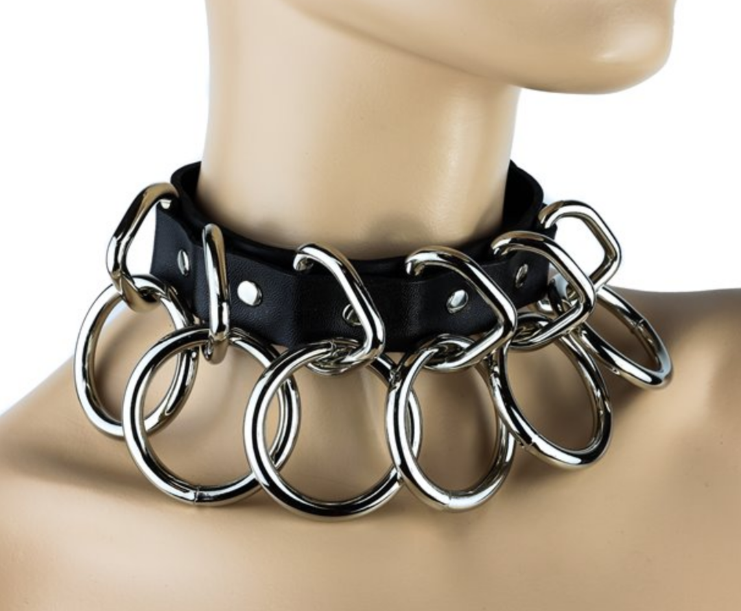 A mannequin displaying the black and silver Two Layer Ring Collar with six rings.