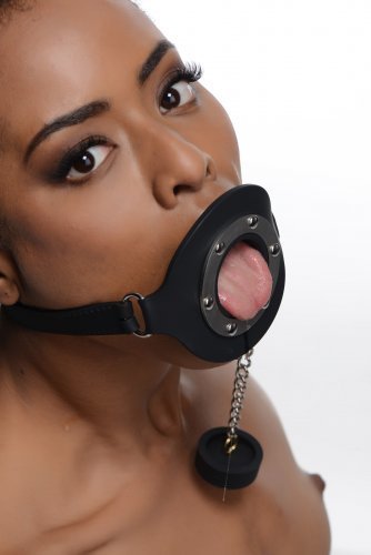 A model sticking her tongue through the opening of the Pie Hole Silicone Feeding Gag.
