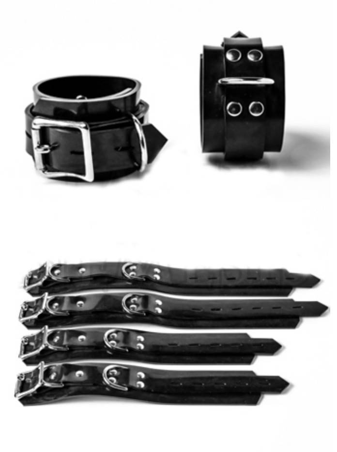 A pair of buckled Heavy Rubber Restraints next to a pair of ankle and wrist Heavy Rubber Restraints open and laid flat.