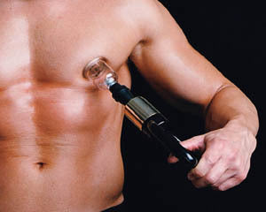 A model holding the pump and a cup against their nipple.