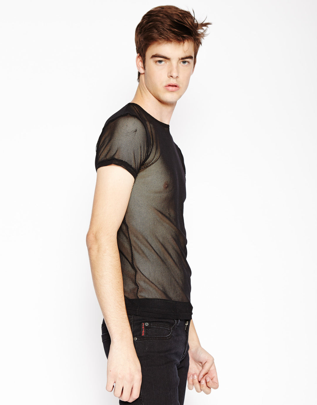 Model wearing the black Short Sleeve Fishnet T-Shirt with black pants, left side view.