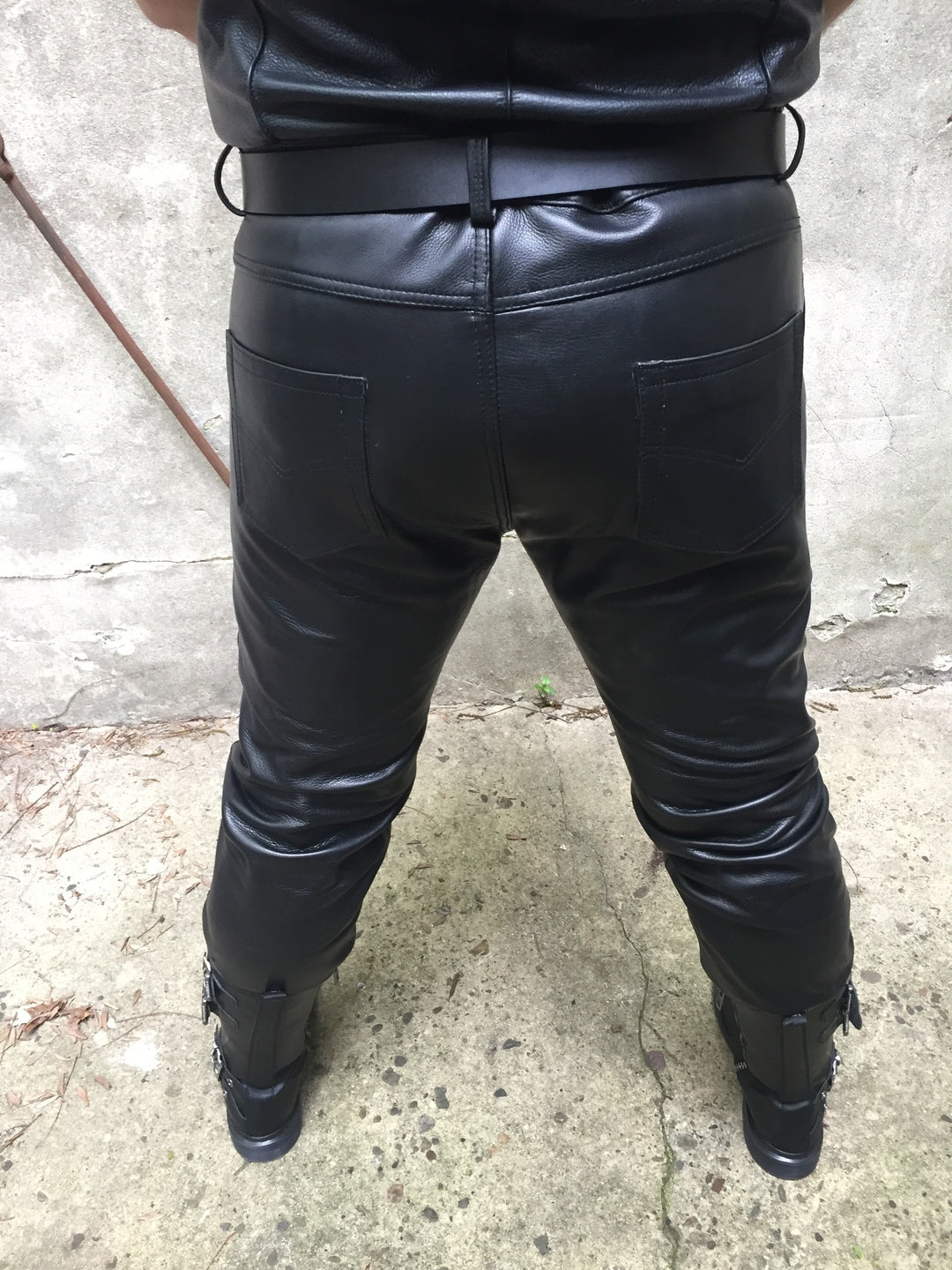 A closer view of a model displaying the back of the Cowhide Levi Jeans.