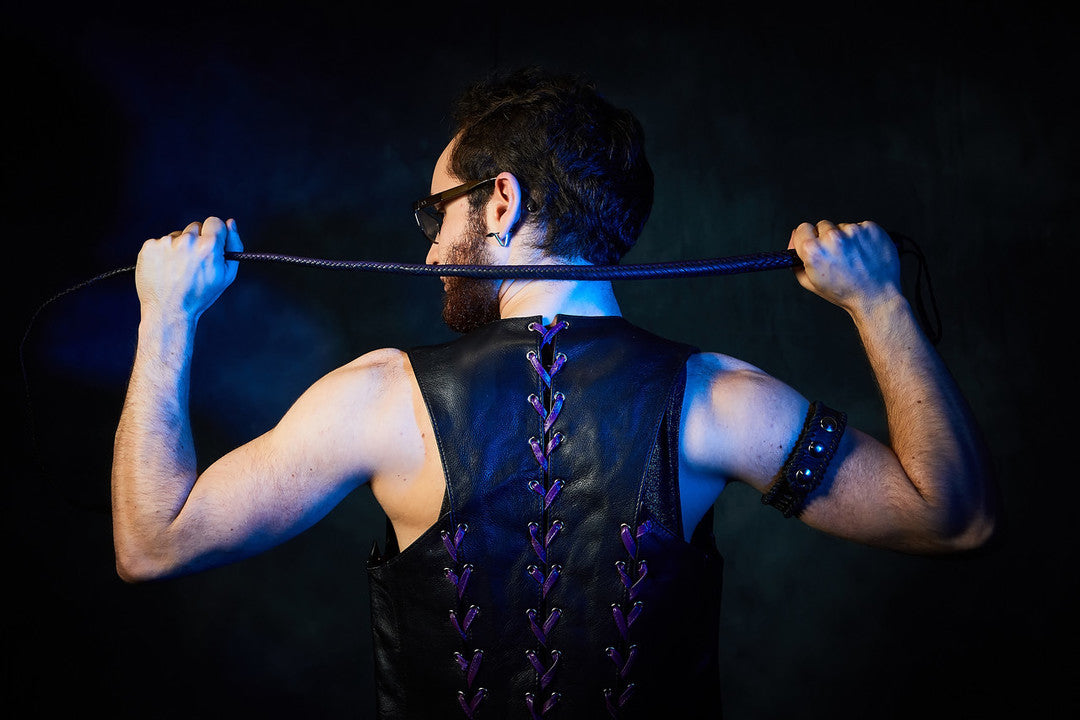 Closeup of the back view of front & back lace cowhide bar vest with purple laces.