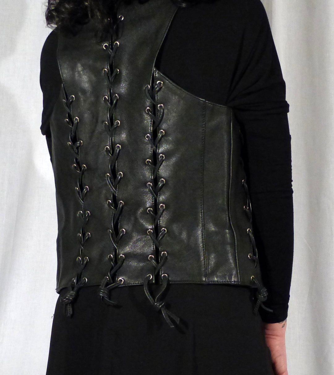 Back and right side view of front & back lace cowhide bar vest with black laces.
