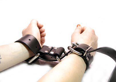 A closer shot of the Restraint Trick Belt being used as handcuffs.