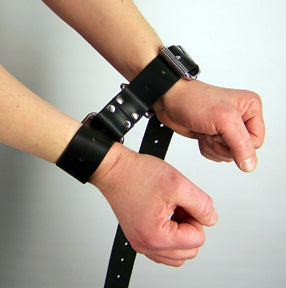 A shot of the Restraint Trick Belt being used as handcuffs.