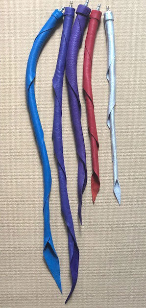 An assortment of Unique Kink Dragon Tail Heads in various sizes and colors.