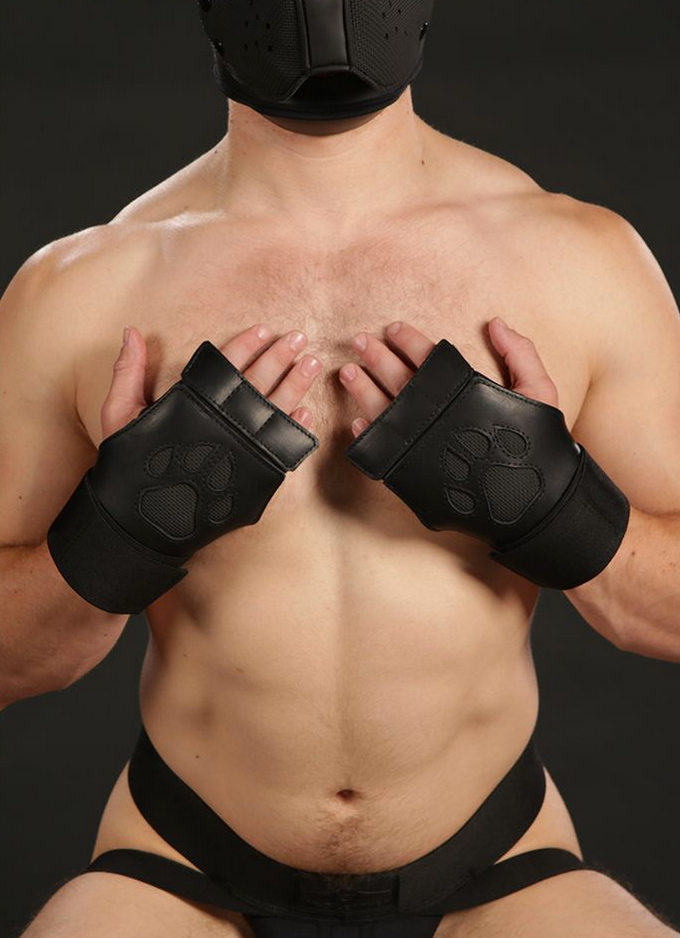 Close up of black open paw puppy gloves being worn by a model.