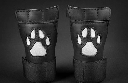 Close up of black/white open paw puppy gloves.