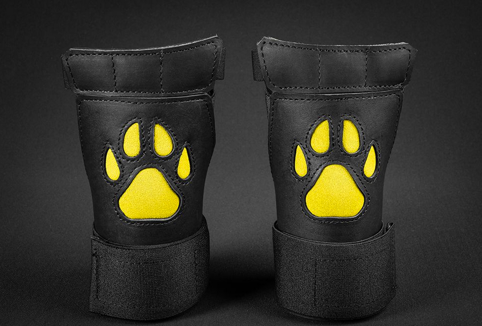 Close up of yellow open paw puppy gloves.