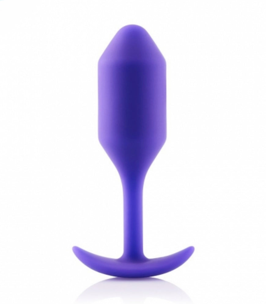 B-Vibe Vibrating Weighted Anal Snug Plug in purple.