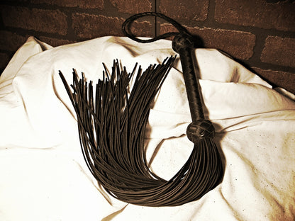 Another angle of the Black Revenge Flogger curled up.