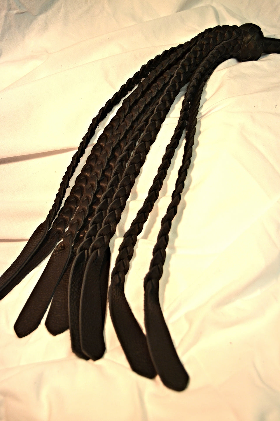 Black Buffalo Braid Flogger displayed so that you can see the ends better.