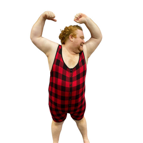 Model wearing plaid bamboo tank onesie with arms in the air, front view.