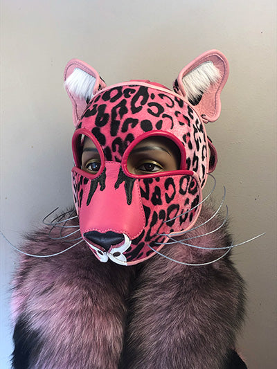 Pink Leather Big Cat mask on mannequin head with a pink and black fur scarf, front view.