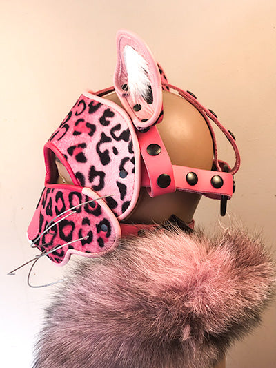 Pink Leather Big Cat mask on mannequin head with a pink and black fur scarf, left side view.