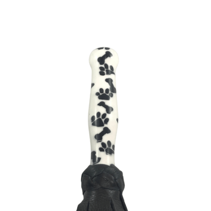 Handle of 3d printed acrylic handle flogger, black puppy.