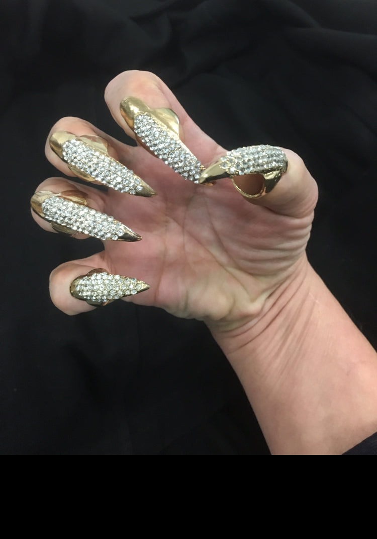 A model's hand wearing the gold Bling Cat Claws.