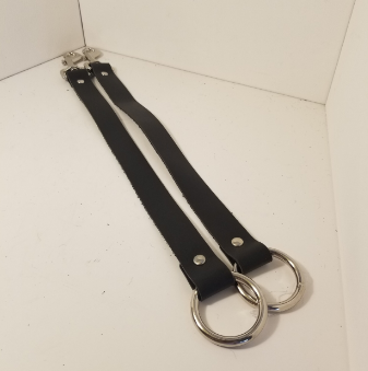 A pair of bondage straps laying parallel to each other.