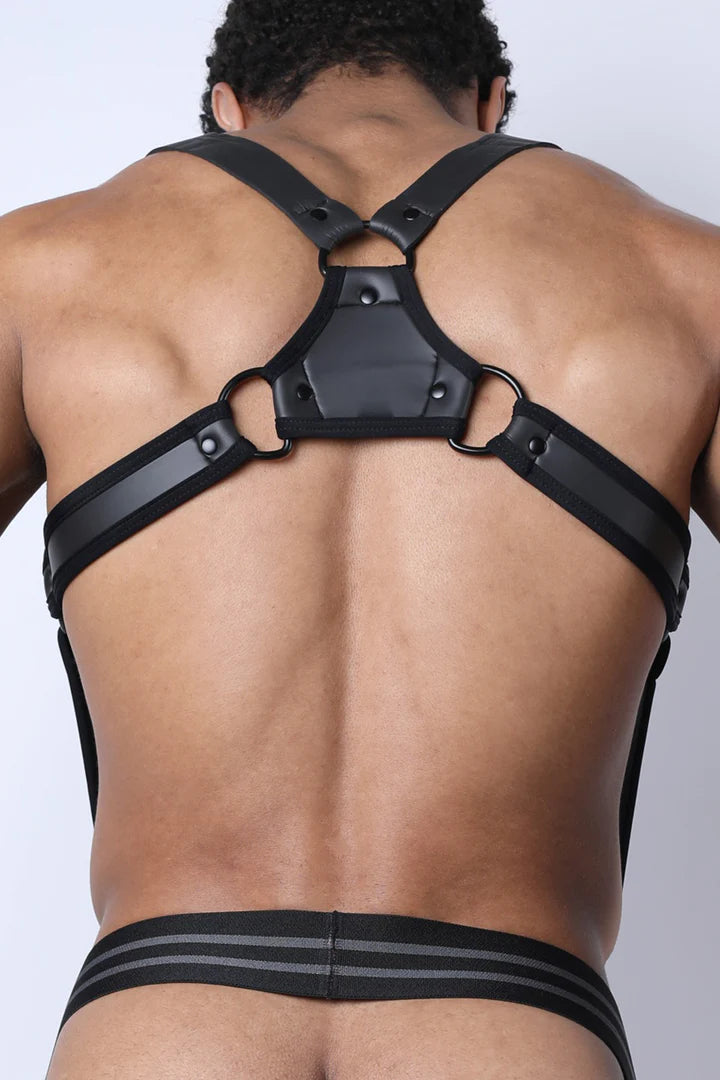 Model showing the back of the black Buckle Up Neoprene Suspender Harness attached to the waistband of a jockstrap.