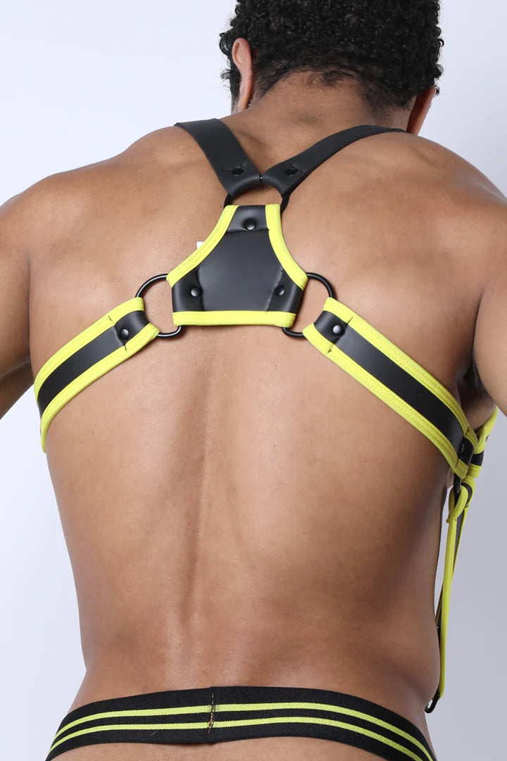 Model showing the back of the yellow and black Buckle Up Neoprene Suspender Harness attached to the waistband of a jockstrap.