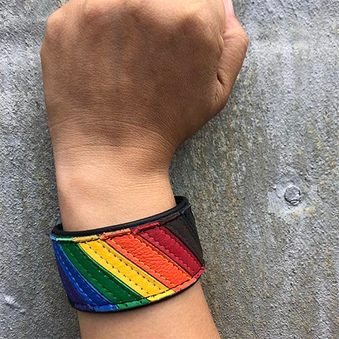 Model wearing Pride flag leather wrist cuff