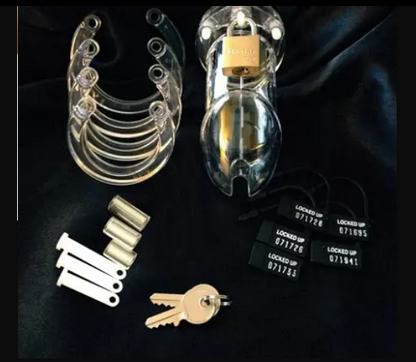 The kit displayed, which includes a CB-6000 Clear Cock Cage, Multiple U-Ring Sizes, Various Locking Pins and Spacers, Strong Brass Lock with 2 Keys, and 5 Numbered Plastic Locks.