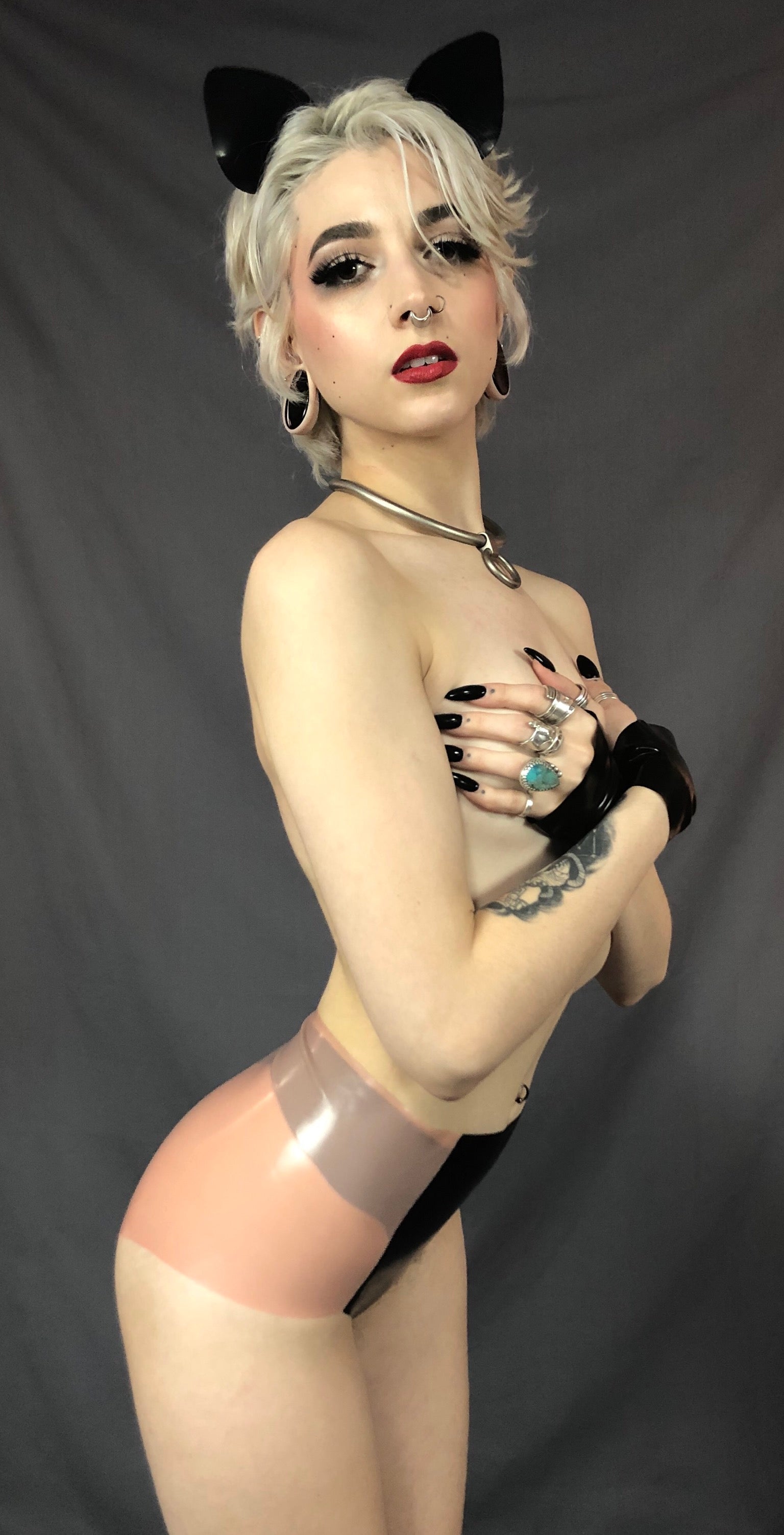 Model wearing cat ears and covering her breasts with her hands showing the side of the Classic Latex Black Panel Panty.